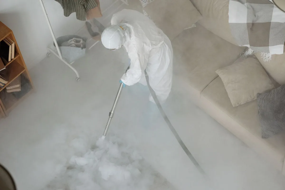 Biohazard cleanup technician in protective equipment, Douglass, KS
